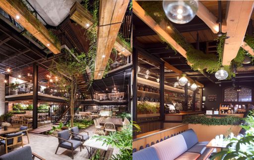 contoh gambar photo desain ruangan kafe ( design interior cafe ) , café with soo many small bulbs, long wood on the ceiing, black sofas, foliages everywhere, wooden tables