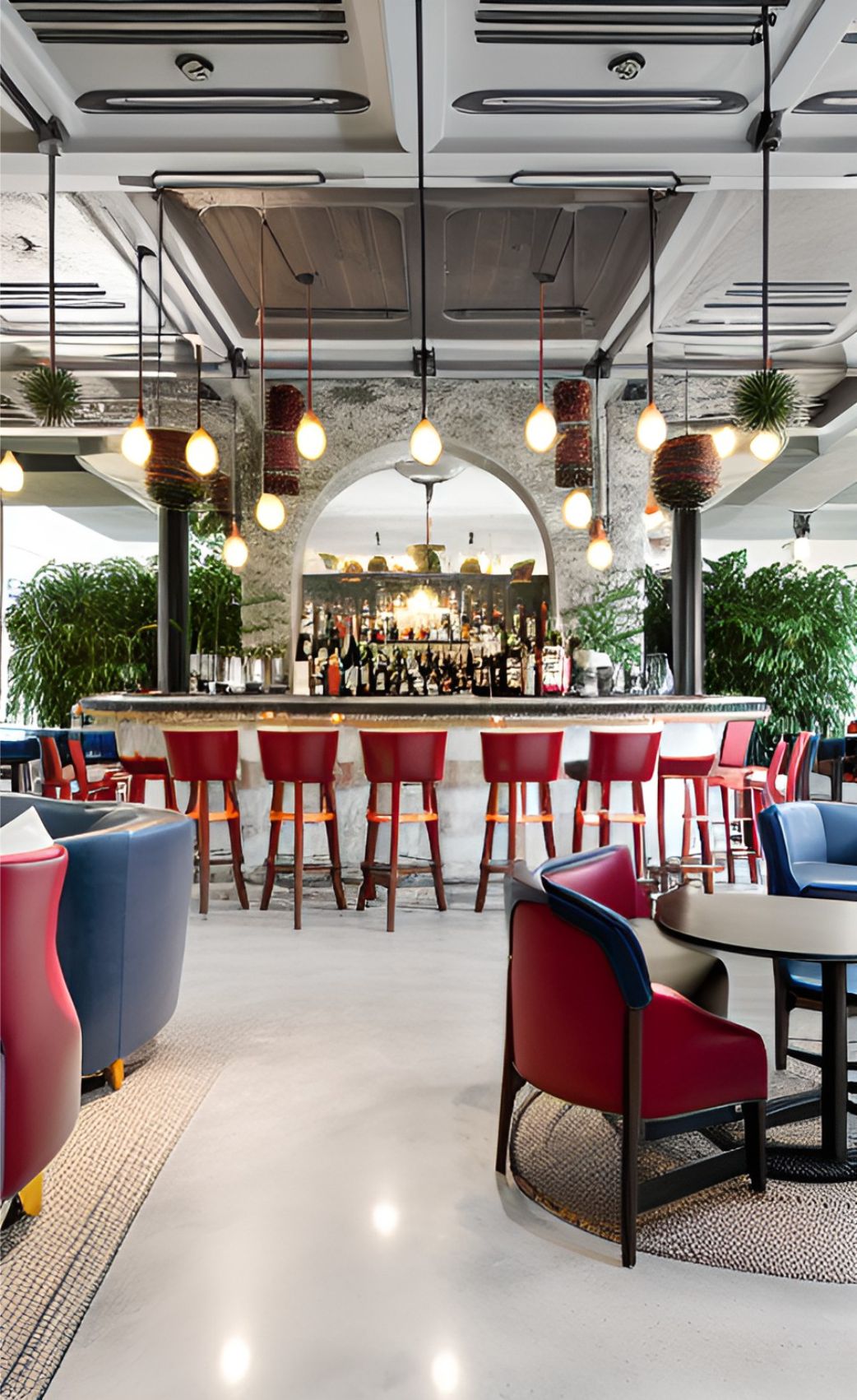 contoh gambar photo desain ruangan restoran kafe ( design interior cafe restaurant ) klasik, restaurant interior with some red and blue unique sofas, classic bar with round stools, unique ceiling textured with concrete, white decorative lamps hanging at ceiling, a big concrete cylindrical pillar, palms grow around the pillar